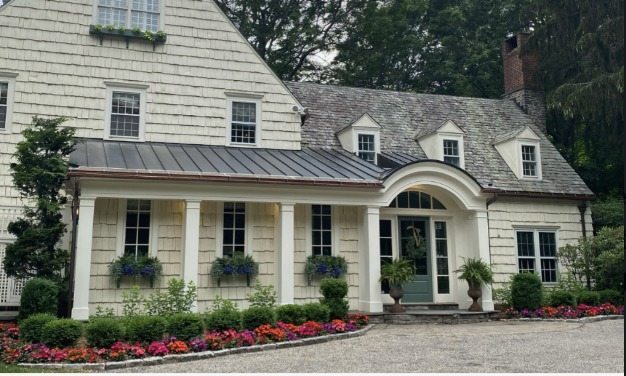 Home entrance with newly installed seasonal plantings and clean bed edging